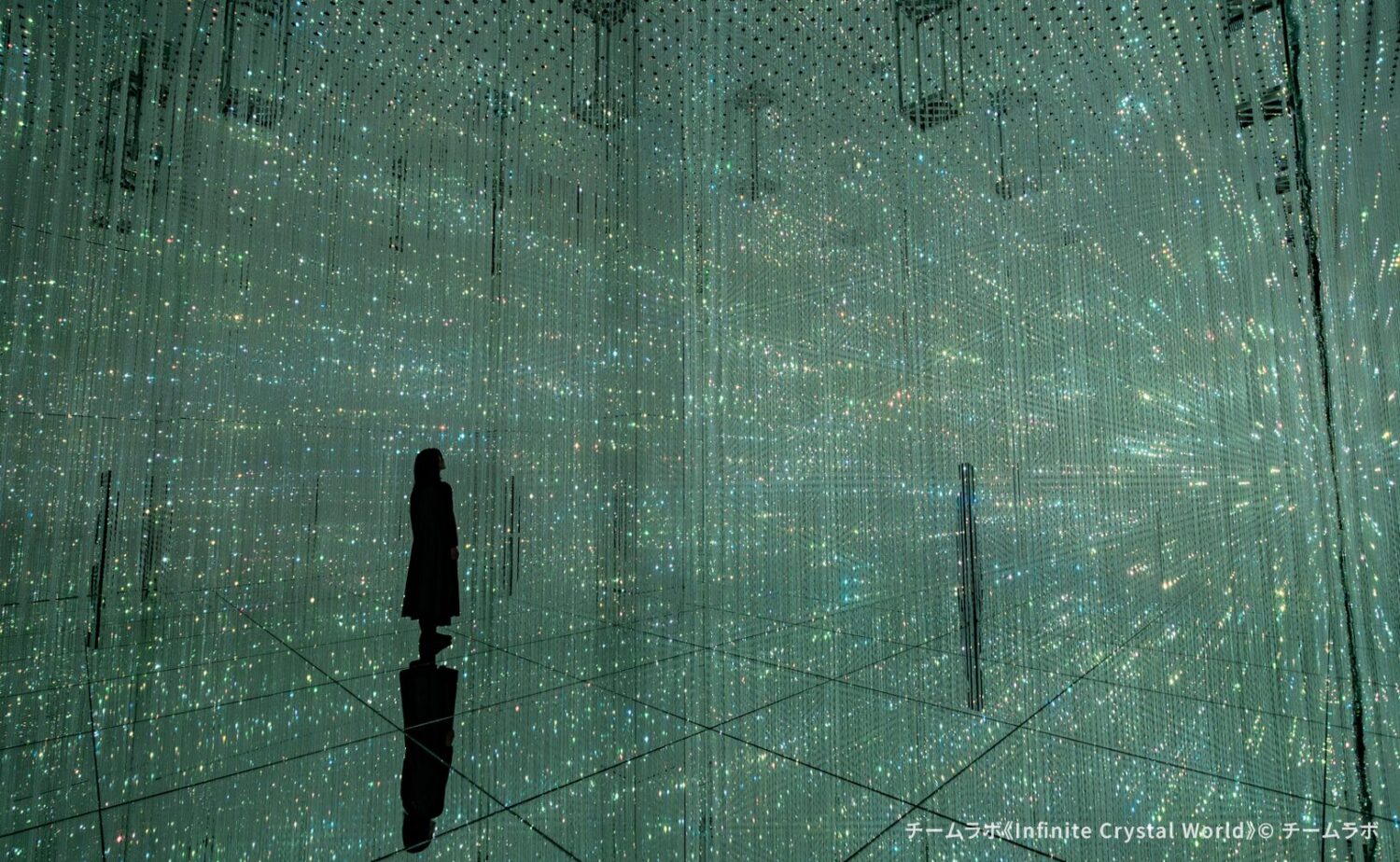チームラボバイオヴォルテクス京都で展示されている作品《Infinite Crystal World》。床面と壁面の鏡に無数の光の点が反射して広がり、光の彫刻が奥行きをもって立体的に無限へ続くインタラクティブな作品空間